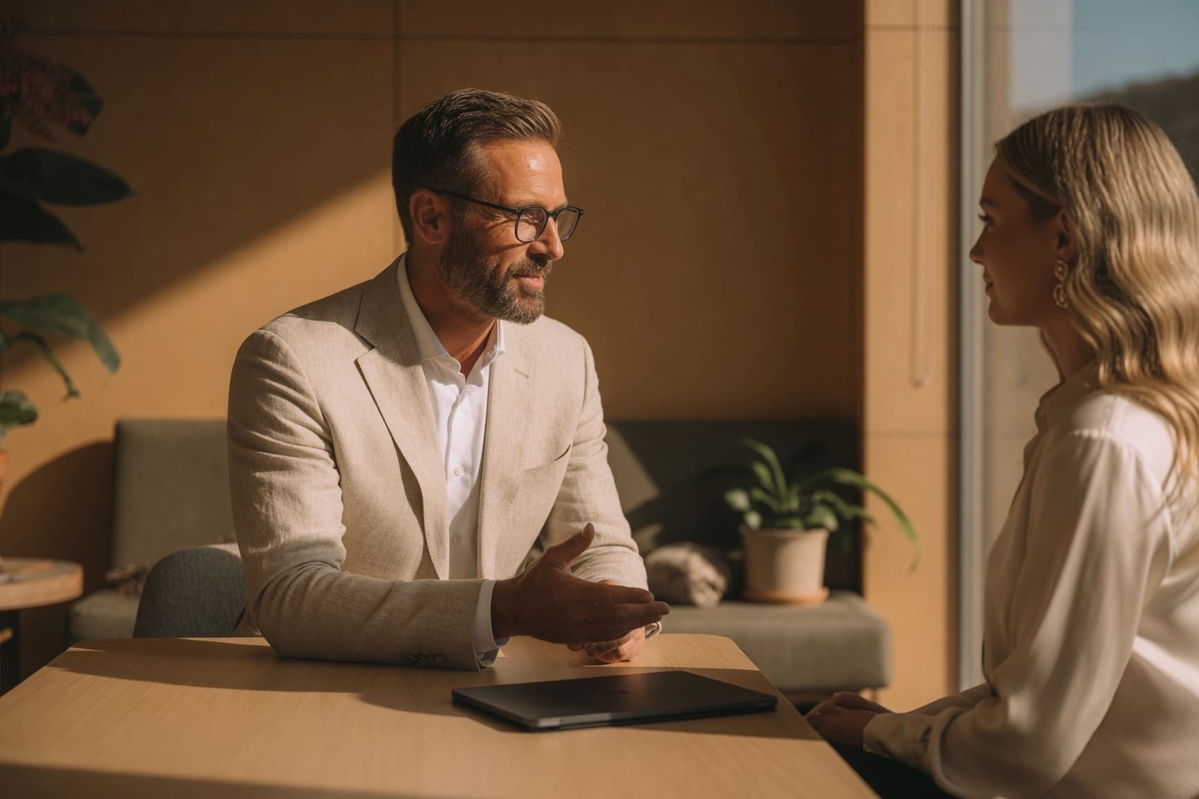 Financial adviser talking with a client across a desk